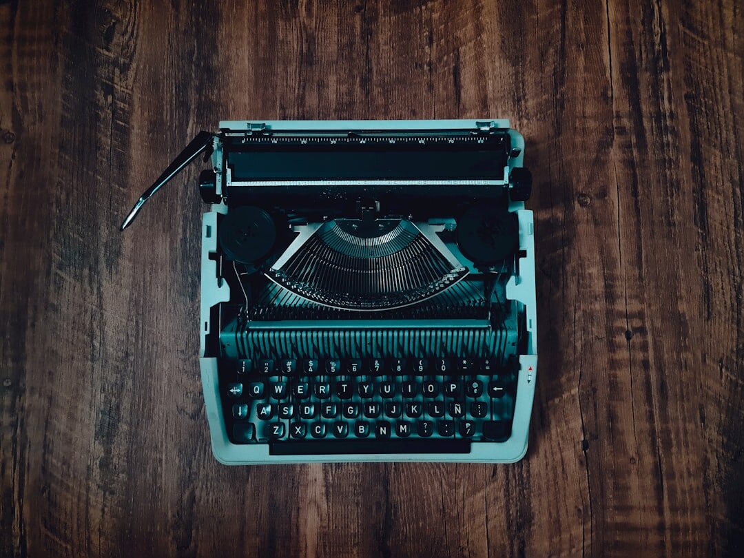 Moody vintage writer's desk with typewriter and dim lamp light